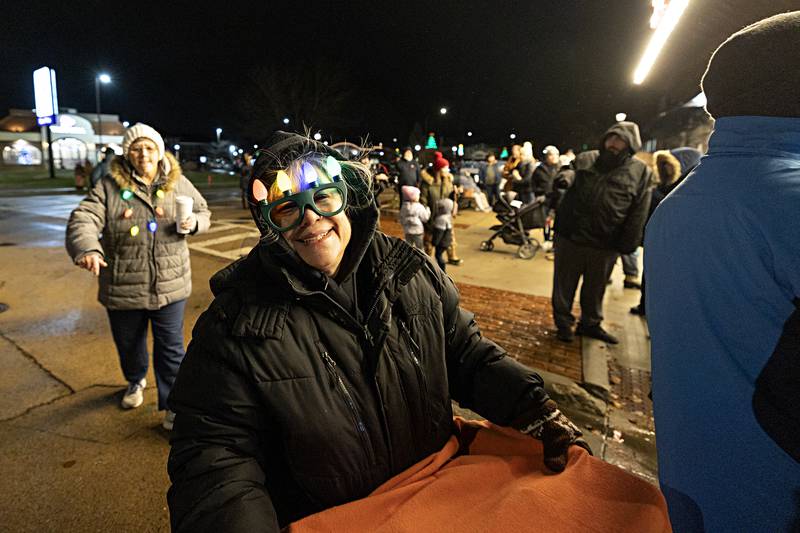 Feeling a little light headed or just maybe just festive, Elisa Gatz moves through the downtown for Sterling’s Christmas walk Friday, Dec. 1, 2023.