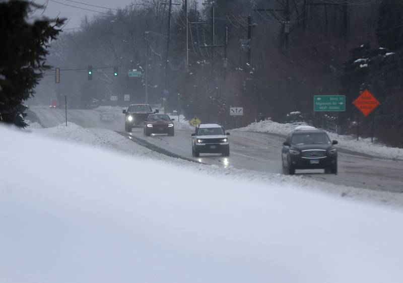 Traffic navigates Walkup Avenue in Crystal Lake on Tuesday, Jan. 23, 2023. Residents throughout northern Illinois woke up to icy and slippery roads.