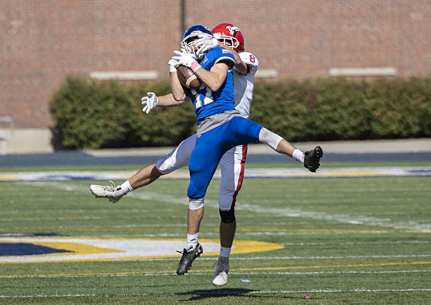 Newman’s Carter Rude hauls in an interception in front of Hall’s Braden Curran Saturday, Oct. 7, 2023.