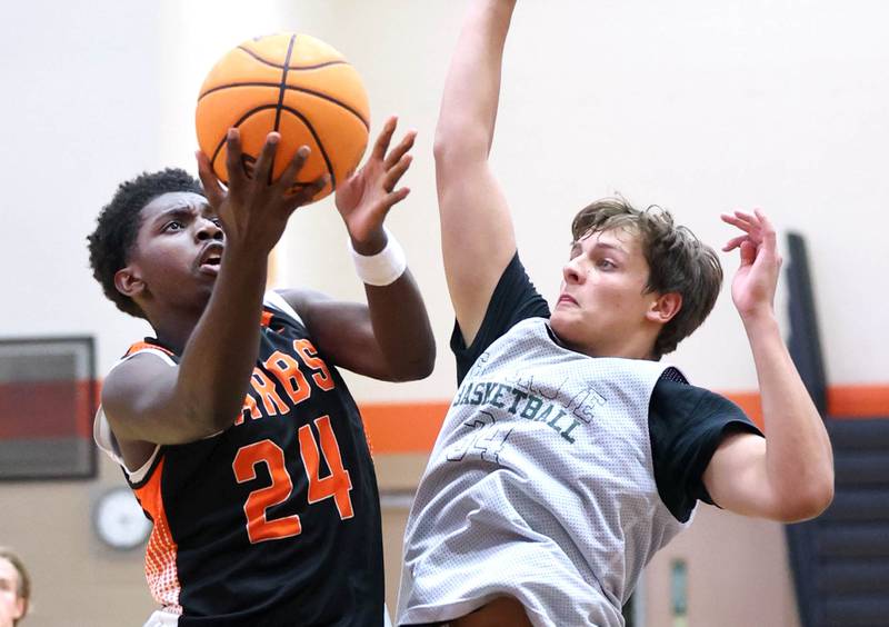 DeKalb’s Myles Newman scores in front of a defender during their summer game against Elk Grove Tuesday, June 18, 2024, at DeKalb High School.