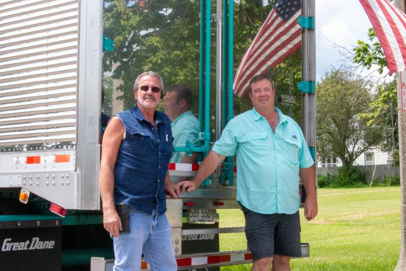 (Left) Doug Cantwell and (Right) Craig DeReu pose behind Craig’s Semi at the Convoy Against Cancer Big Truck Show on Saturday, July 20, 2024 on Main Avenue in Ladd.