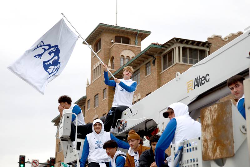 The St. Charles North football team rides during the school’s annual homecoming parade on Main Street through downtown St. Charles on Thursday, Oct. 19, 2023.