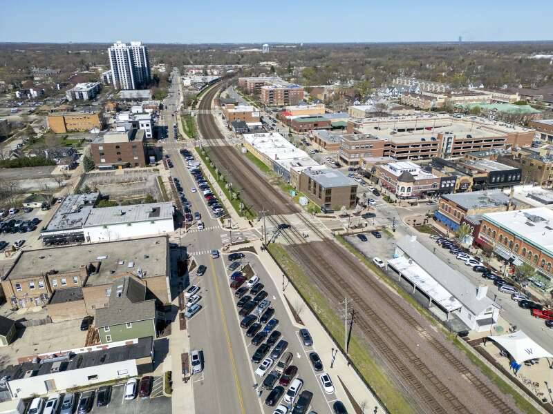 A developer aims to build an apartment complex on the south side of the train tracks running through Wheaton's downtown. This view looks west along Liberty Drive downtown.