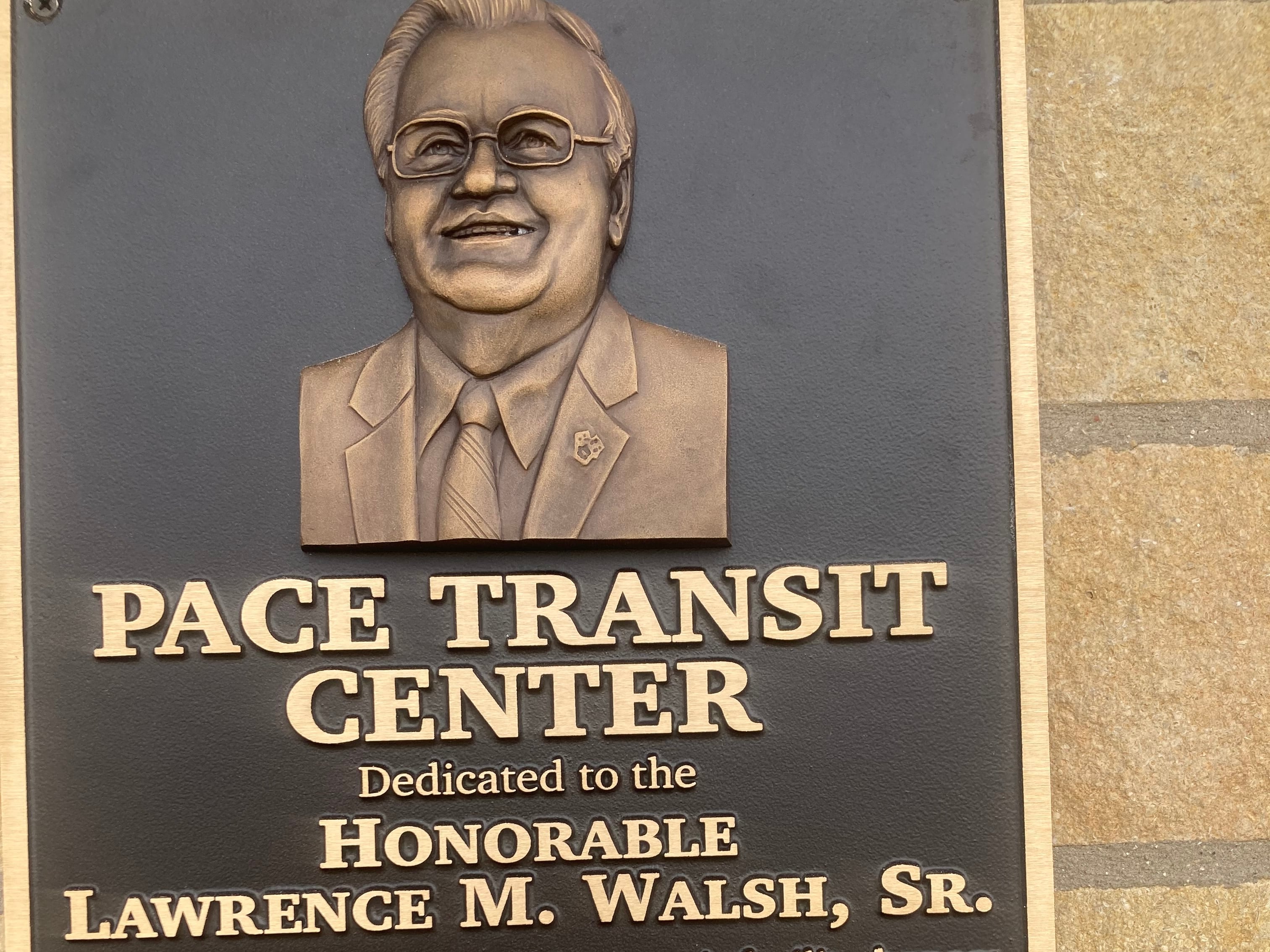 A plaque at the Pace bus terminal in Joliet dedicating the transit hub to former State Senator and Will County Executive Larry Walsh, Sr.