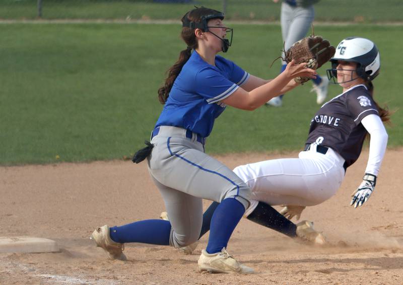 Cary-Grove’s Holly Streit, right, is safe at third with a steal against Burlington Central in varsity softball at Cary Monday.
