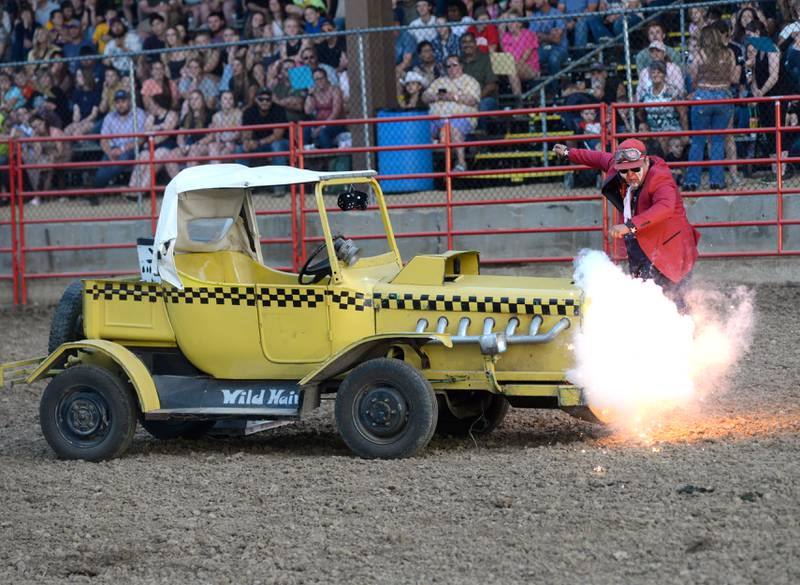 Rodeo clown Trey Casey has an issue with his vehicle during a break in the action at the Big Hat Rodeo during the Ogle County Fair on Friday, Aug. 4, 2023.