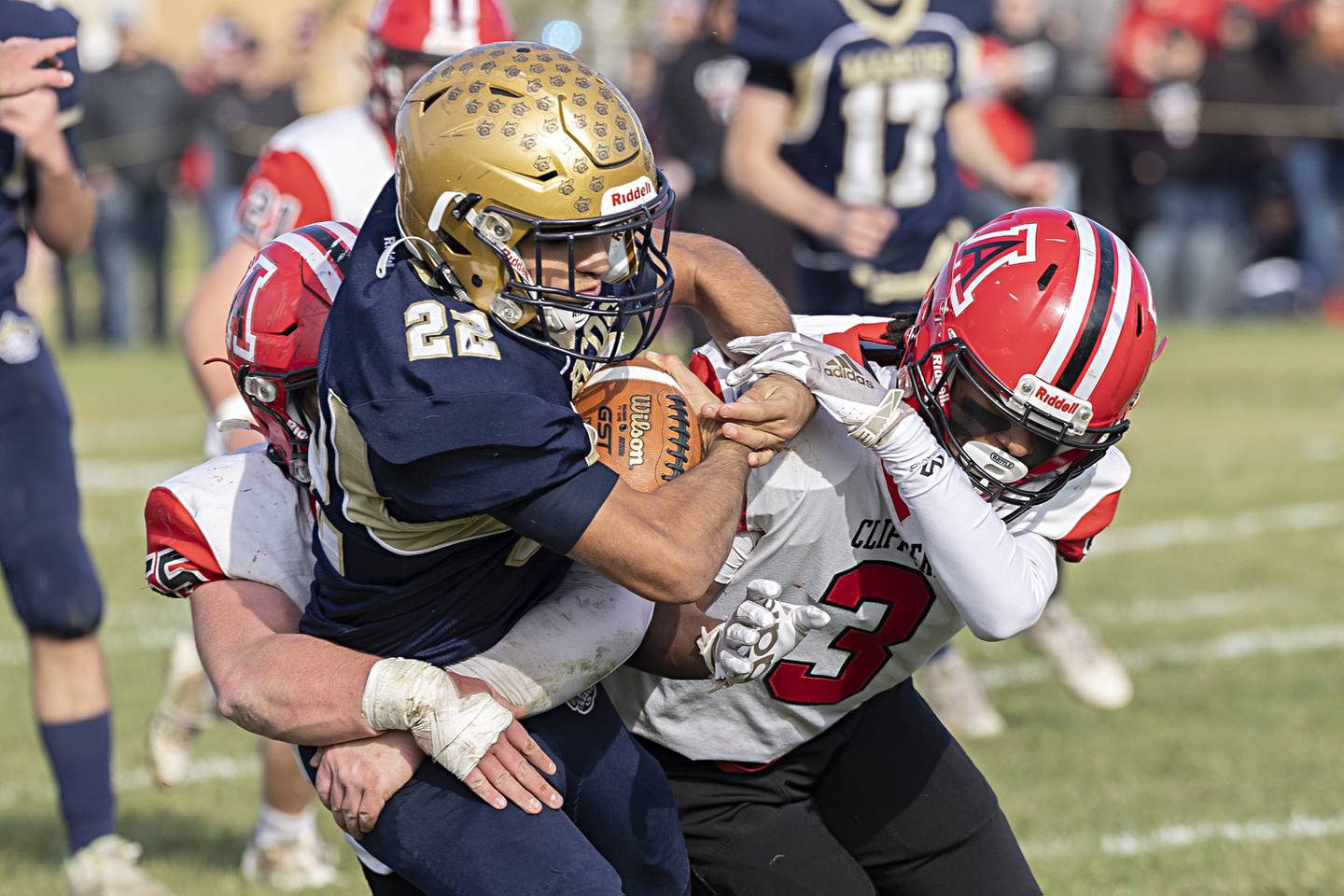 Polo’s Delo Fernandez is tackled by Landon Montavon (left) and Cody Winn Saturday, Nov. 11, 2023 during a semifinal 8-man football game in Polo.