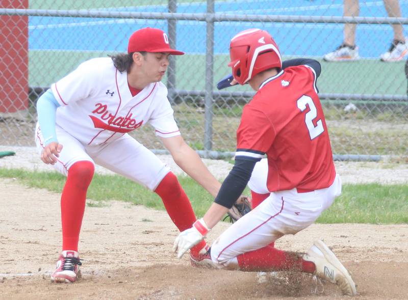 Ottawa pitcher Cam Loomis misses the tag on Streator's Zander McCloskey on a pass ball at home plate on Tuesday, May 14, 2024 at Streator High School.