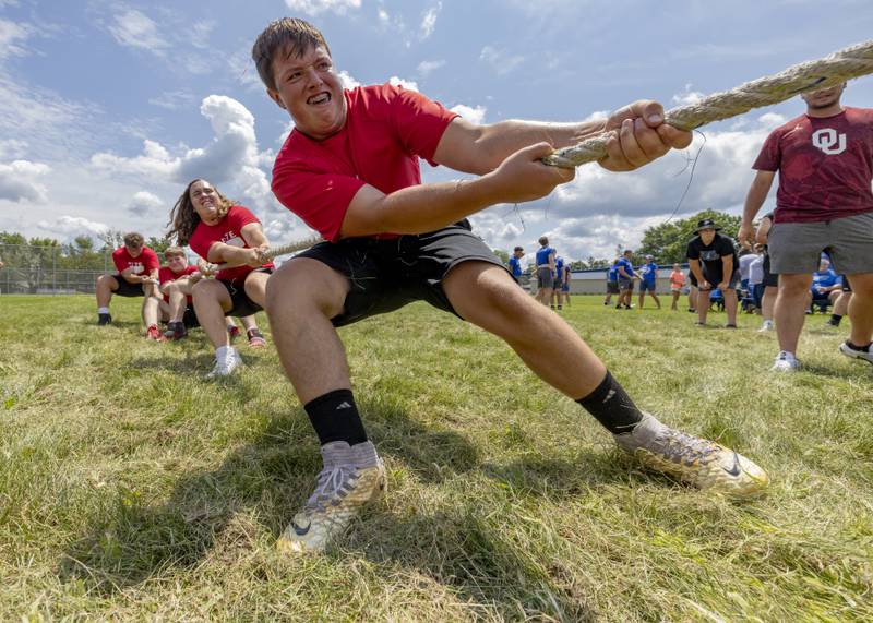 Cooper Smith and his Ottawa Pirate teammates struggle to gain ground against Sandwich Highschool during the final game of tug of war during a multiple high school practice football meet at Princeton High School on July 20, 2024.