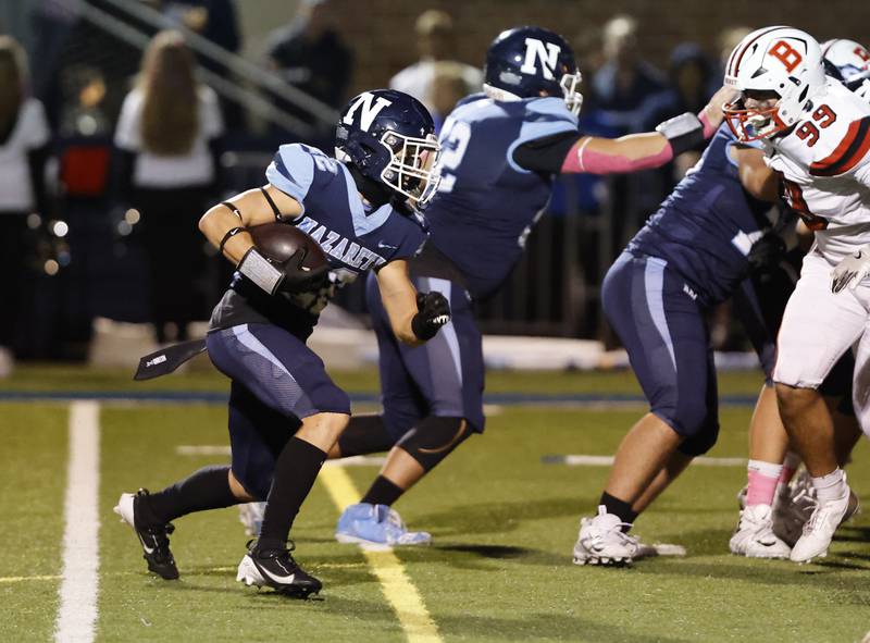 Nazareth's Anthony Donato (22) runs the ball during the varsity football game between Benet and Nazareth academies on Friday, Oct. 18, 2024 in La Grange Park.