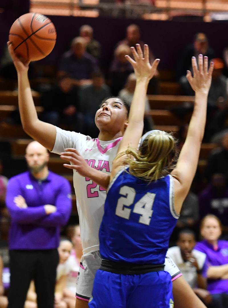 Downers Grove North's Kaitlyn Parker lays the ball up as Lyons Township's Kennedy Wanless defends during a game on Jan. 30, 2024 at Downers Grove North High School in Downers Grove .