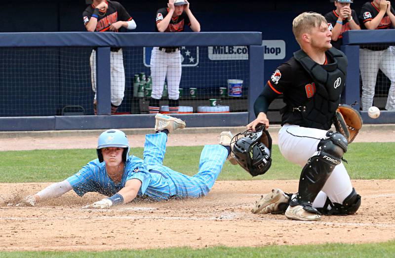 The ball gets away from Altamont catcher Nathan Stuemke as Marquette's Griffin Dobberstein scores a run during the Class 1A State championship game on Saturday, June 1, 2024 at Dozer Park in Peoria.