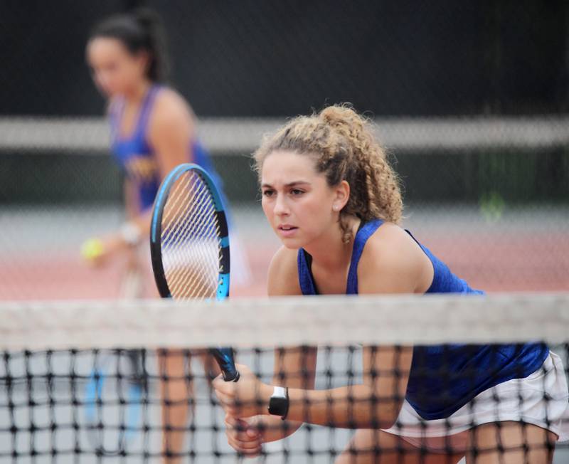 Doubles player Stella Tarsha, right, of Wheaton North in a match with her partner Kaylee Phillips at the DuKane Conference girls tennis tournament at Wheaton Warrenville South High School on Thursday, October 5, 2023.