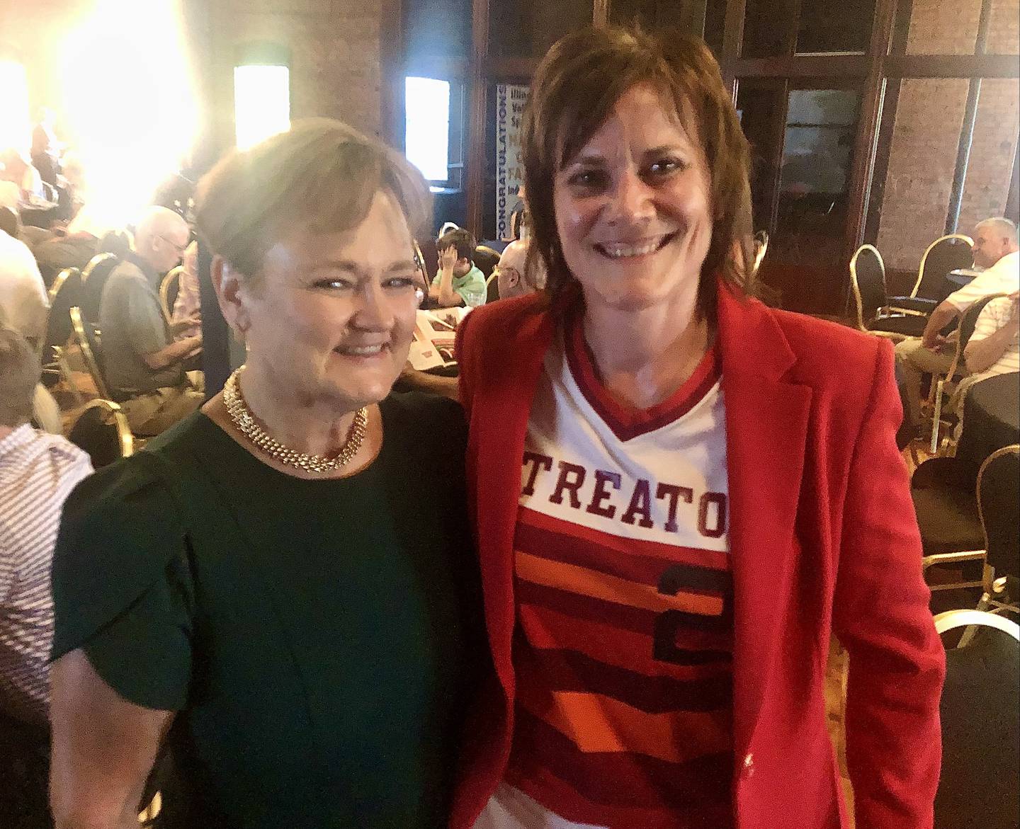 Two of the stars of the 1983 Streator state softball champions, Zami (Mogill) Haye and Amy Ferko huddle up during Thursday's NewsTribune's Illinois Valley Sports Hall of Fame banquet in LaSalle.