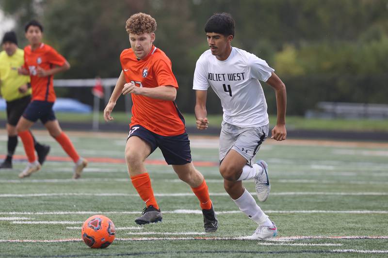 Romeoville’s Gjon Osmani and Joliet West’s Marcos Hernandez run down the ball on Wednesday, Oct. 11, 2023 in Romeoville.