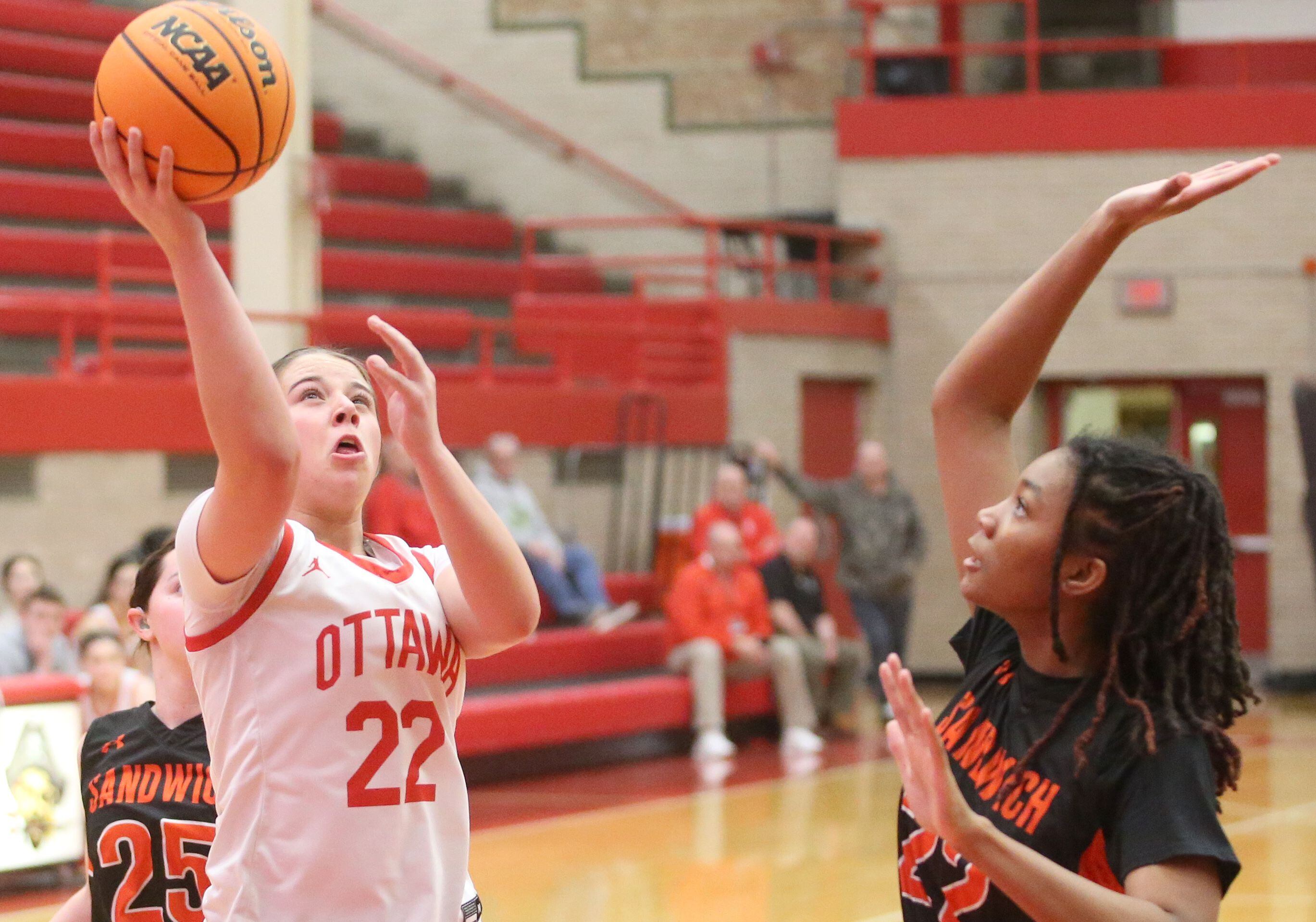 Ottawa's Marlie Orlandi eyes the hoop while taking a jump shot over Sandwich's Alayla Harris on Monday, Jan. 27, 2025 in Kingman Gym at Ottawa High School. 