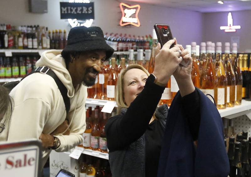 Retired Chicago Bulls star Scottie Pippen poses for a selfie with a fan after he signed a bottle of his Digits bourbon Thursday, Feb. 9, 2023, at The International House of Wine and Cheese, at 11302 Route 12, in Richmond.