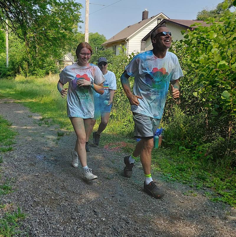 Scott and Gabby Jacobs, of Streator, finish the Safe Journeys Color Run on Saturday, June 17, 2023, on the Hopalong Cassidy Trail in Streator.