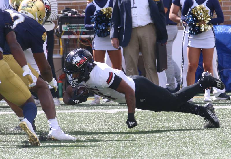 NIU's Chris Carter lunges forward to get extra yards while playing Notre Dame on Saturday, Sept. 7, 2024 at Notre Dame Stadium.