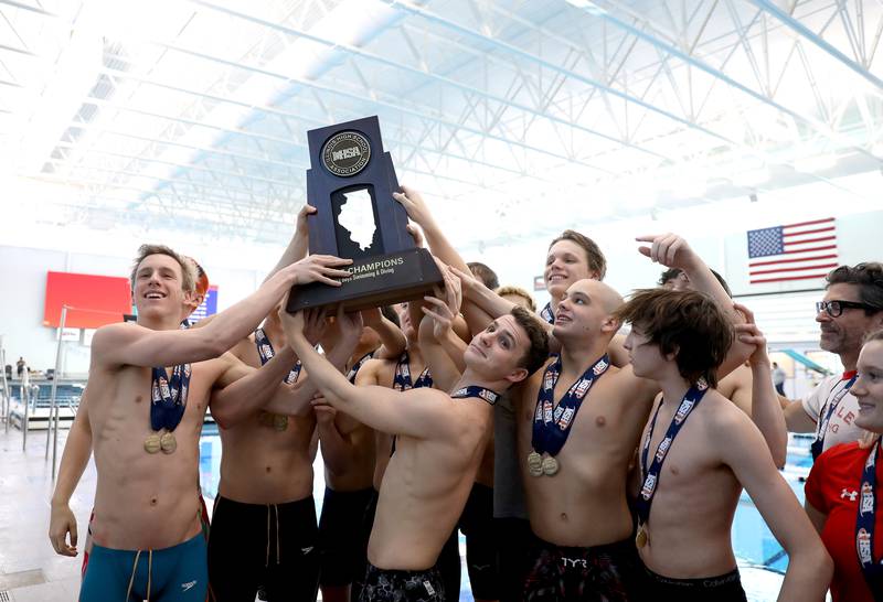 Hinsdale Central swimmers celebrate their first-place finish in the IHSA Boys State Championships at FMC Natatorium in Westmont on Saturday, Feb. 25, 2023.