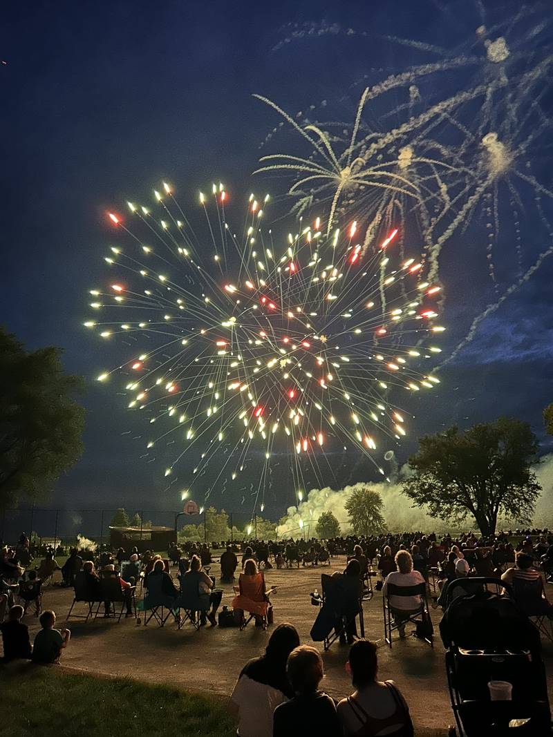 Spectators watch as a heart forms in one of the  fireworks at Let Freedom Ring in Mt. Morris on Thursday, July 4, 2024.
