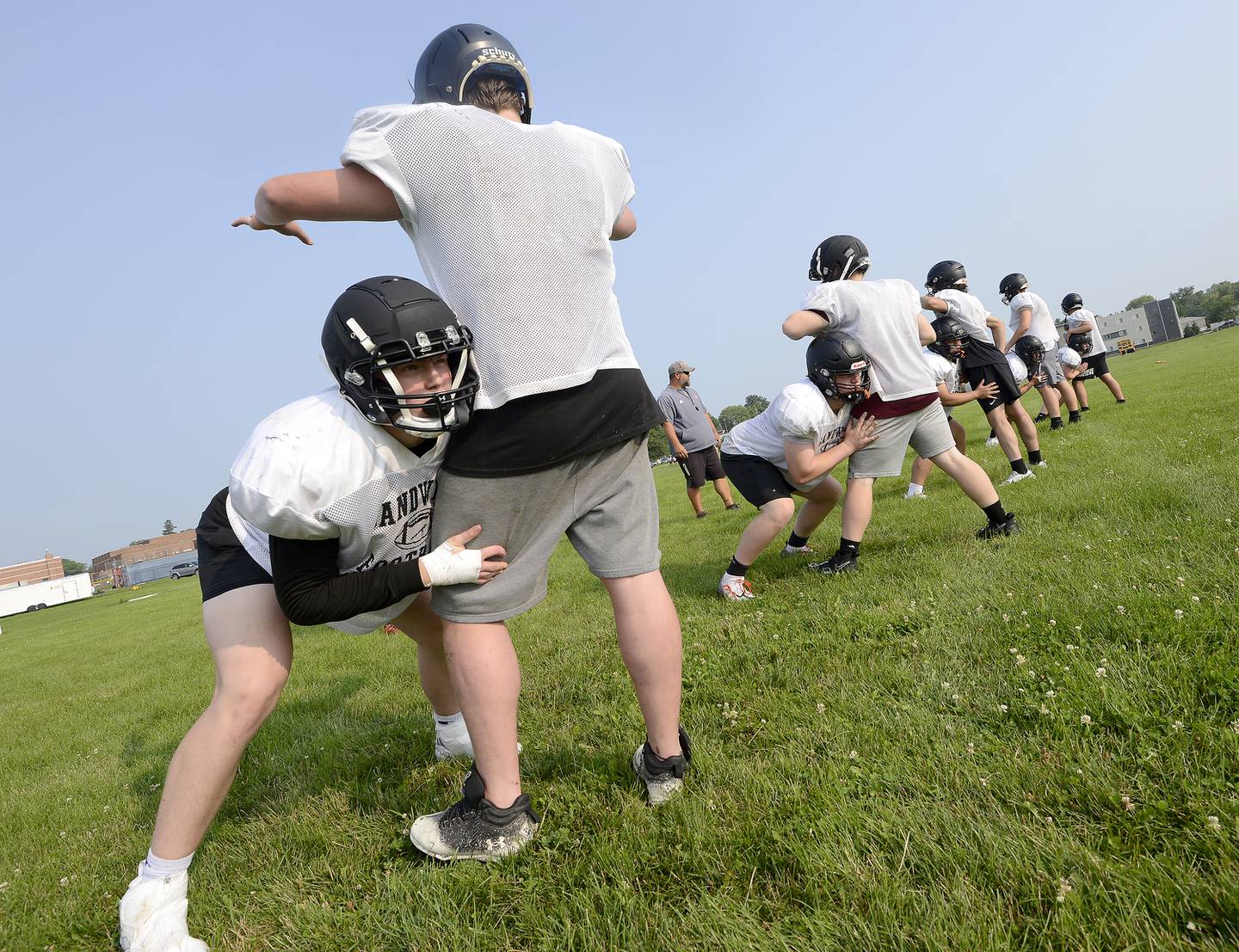 Sandwich linemen Pater Popp (left) and Jackson Heilemeier work on blocking drills during early summer football practice at Sandwich High School on Monday, July 17, 2023.