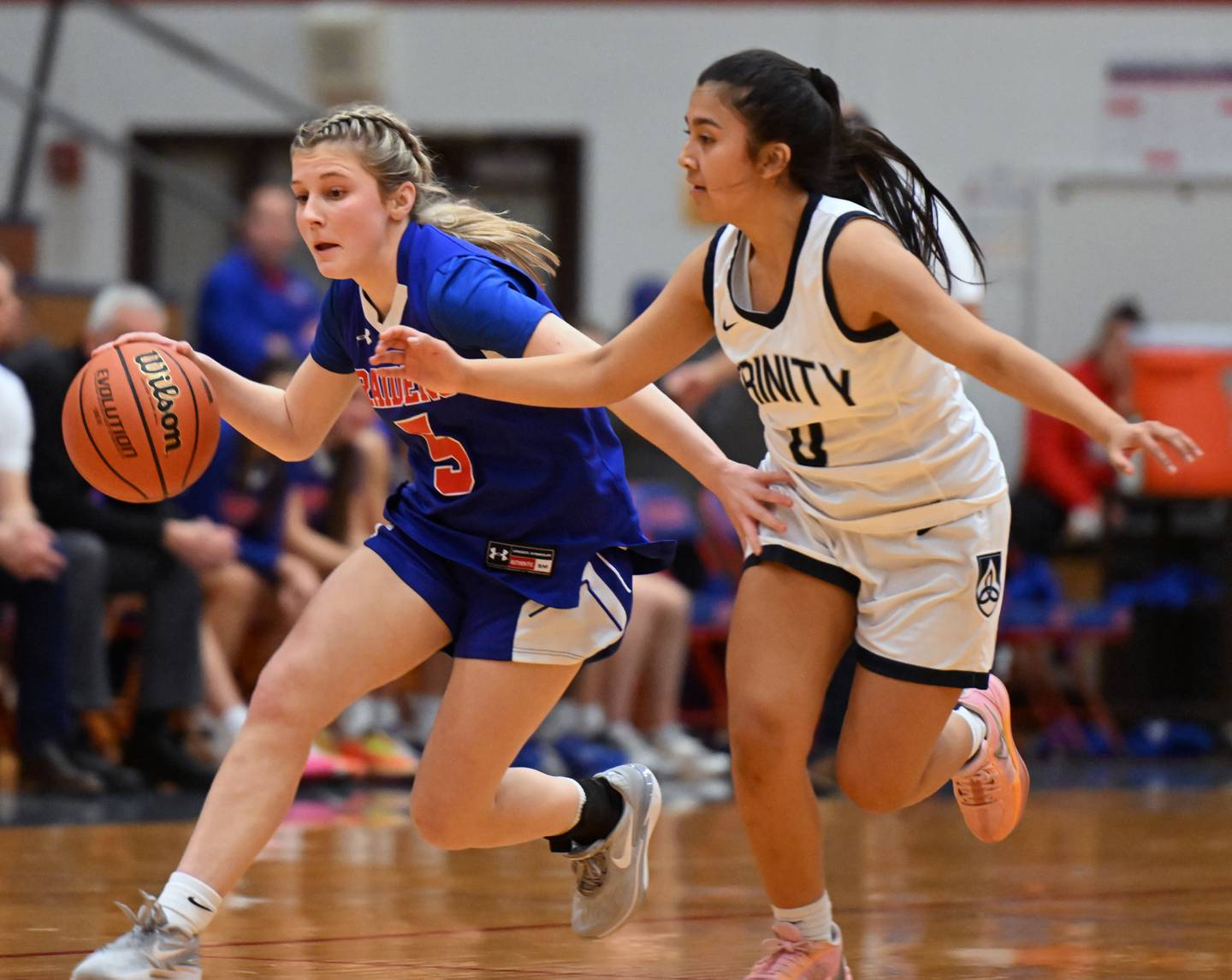 Glenbard South’s Jamie Mizwicki, left, leads a fast break as Trinity’s Jaylani Hernandez defends during the Class 3A Glenbard South girls basketball sectional semifinal on Tuesday, Feb. 20, 2024 in Glen Ellyn.