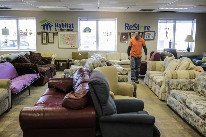 Patrick Royce shops Friday for a couch at the Habitat for Humanity ReStore in Joliet.