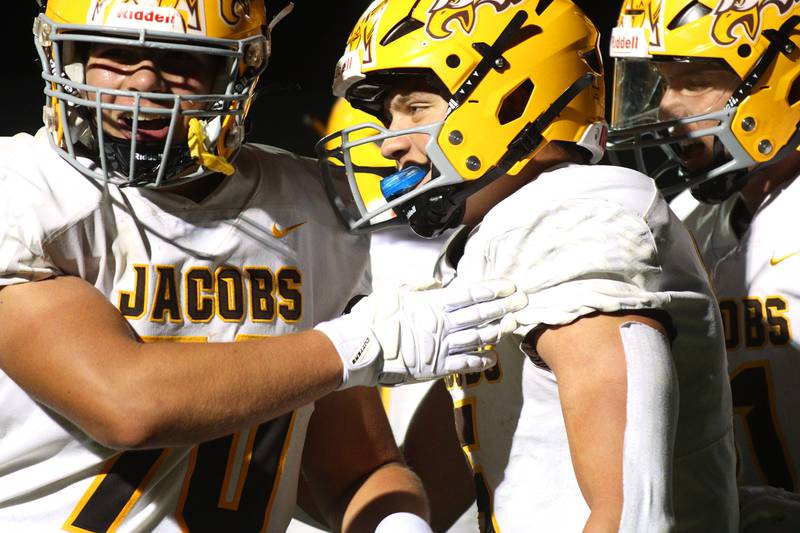 Jacobs’  Matt Scardina, center, is greeted in the end zone after a touchdown in varsity football on Friday, Sept. 6, 2024, at Hampshire School in Hampshire.