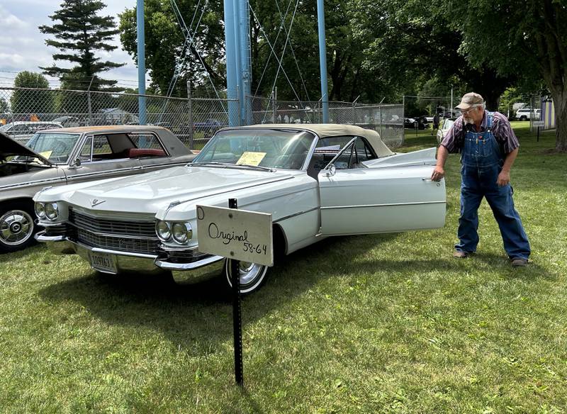 Jeff Doyle of Albany shuts the driver's door on his 1963 Cadillac convertible at the Lyndon Car Show on Sunday, June 2, 2024. The event was held in Richmond Park in Lyndon