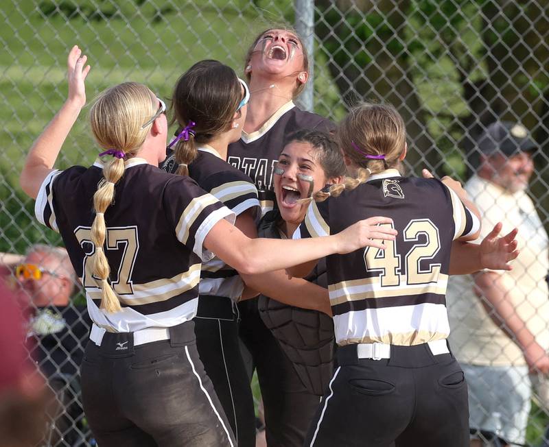 Sycamore players celebrate after the final out of their Class 3A sectional final win over Prairie Ridge Friday, May 31, 2024, at Sycamore High School.
