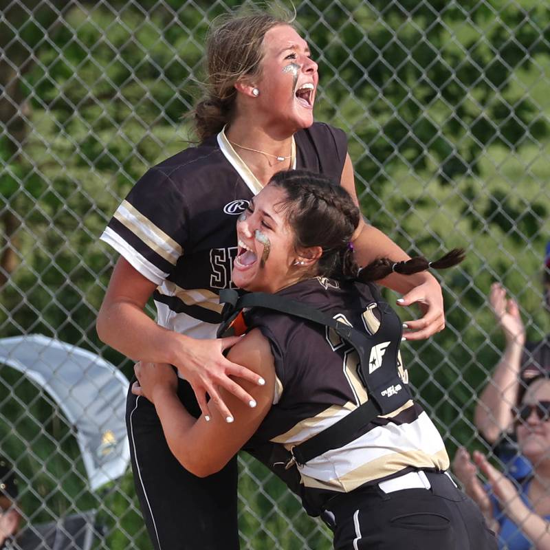 Sycamore pitcher Addison Dierschow and catcher Kairi Lantz celebrate after the final out of their Class 3A sectional final win over Prairie Ridge Friday, May 31, 2024, at Sycamore High School.