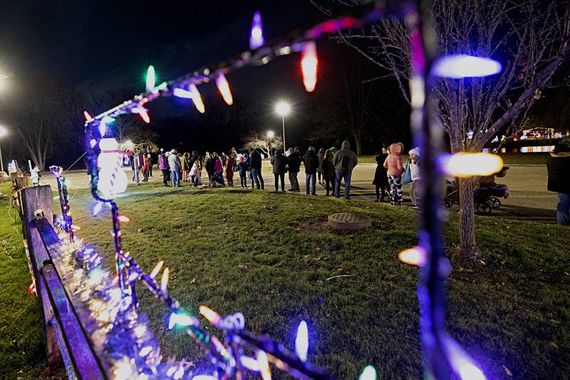 Visitors wait to board one of two horse-drawn carriages Saturday, Nov. 25, 2023 in Rock Falls.