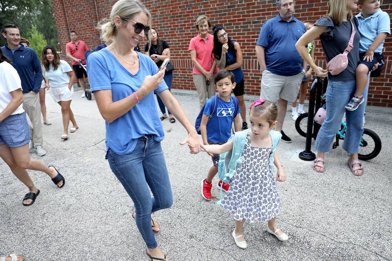 Julie Orozco walks her kindergartner daughter, Sophia, on the first day of school at Whittier Elementary School in Downers Grove on Friday, Aug. 25, 2023.