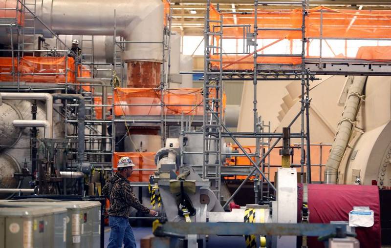 An employee walks though the turbine room at the Byron Generating Station Tuesday, Oct. 17, 2023, in Byron.