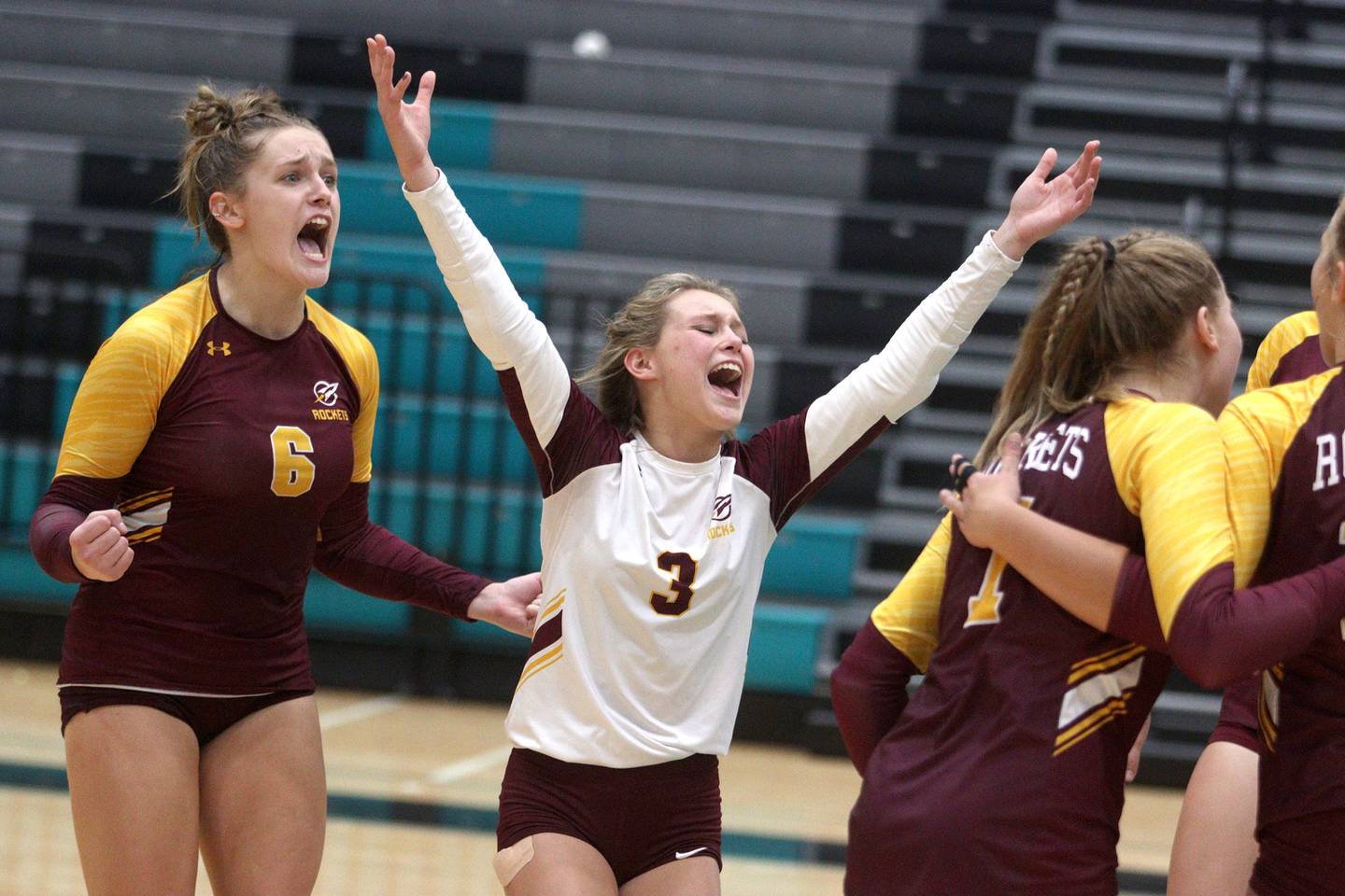 Richmond-Burton’s Elissa Furlan, left, and Lanie Cooley celebrate a point in varsity volleyball at Woodstock North Monday night.