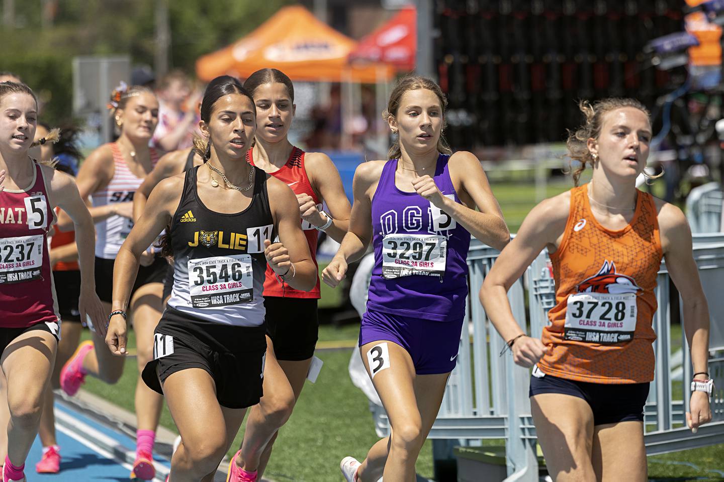 Downers Grove North’s Ava Gilley (in purple) runs with the pack in the Class 3A 800-meter run in May 2024 at the IHSA girls state track meet in Charleston.