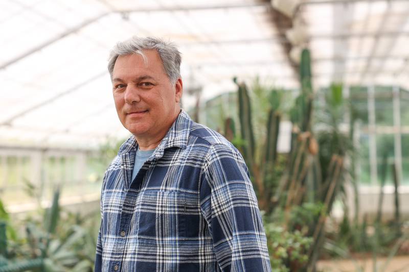 Kevin Eberhard, chief horticulturist at the Birdhaven Greenhouse in Pilcher Park who is retiring after 33 years, poses for a photo on Tuesday, May 21, 2024 in New Lenox.