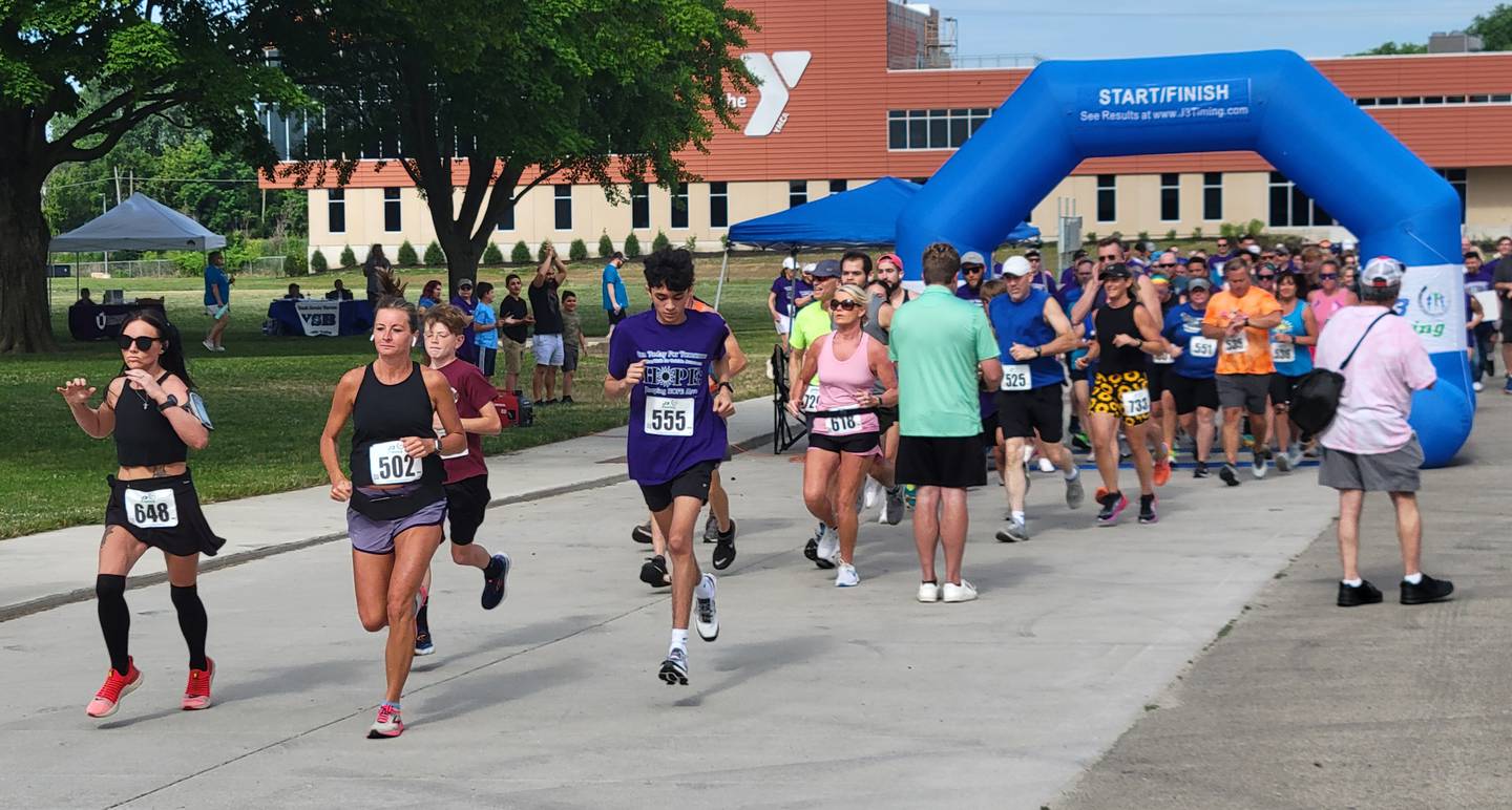 Runners dodge photographers at the start of Saturday's Run Today For Tomorrow 5K run/walk for suicide awareness held on Ottawa's riverfront.