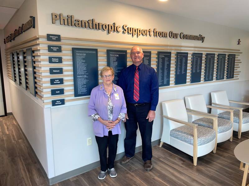 Morris Hospital Foundation Board President George McComb and Volunteer Beth Clampitt view the new philanthropic display off the hospital main lobby that recognizes donors and volunteers for their support.