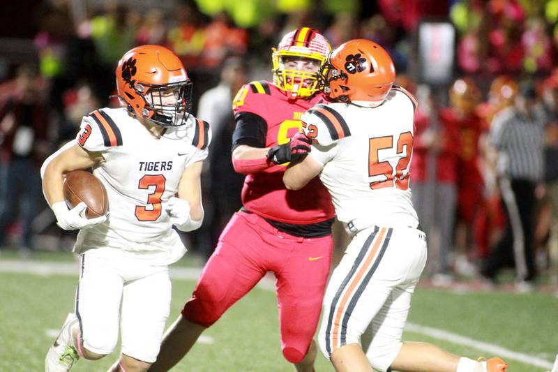 Wheaton Warrenville South’s Owen Yorke runs the ball as Batavia’s Gavin Pecor tries to get past Wheaton Warrenville South’s Rory Masse on Friday, Oct. 18, 2024 during a game at Batavia.