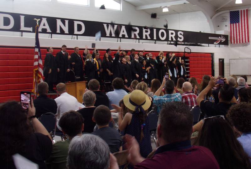 Woodland Class of 2024 graduates toss their hats into the air to conclude the ceremony Sunday, May 19, 2024.