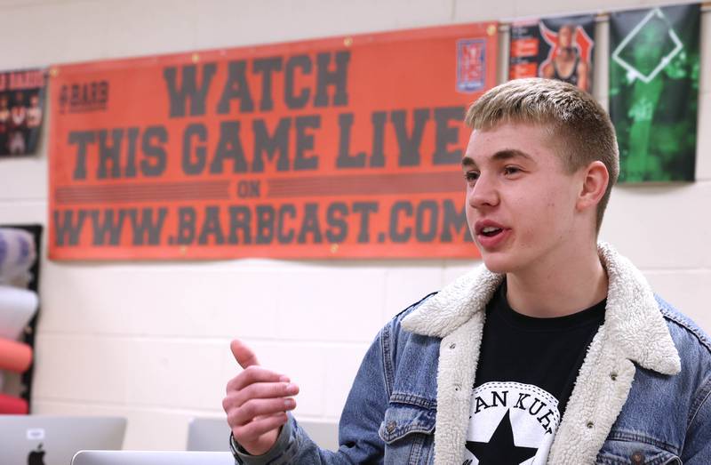 Lane Schumacher, a senior at DeKalb High School, talks Thursday, March 7, 2024, at the school, about what his experience has been like being a part of the BarbCast team. The BarbCast network broadcasts live streaming video of sports and events at the school as well as putting together promotional materials.