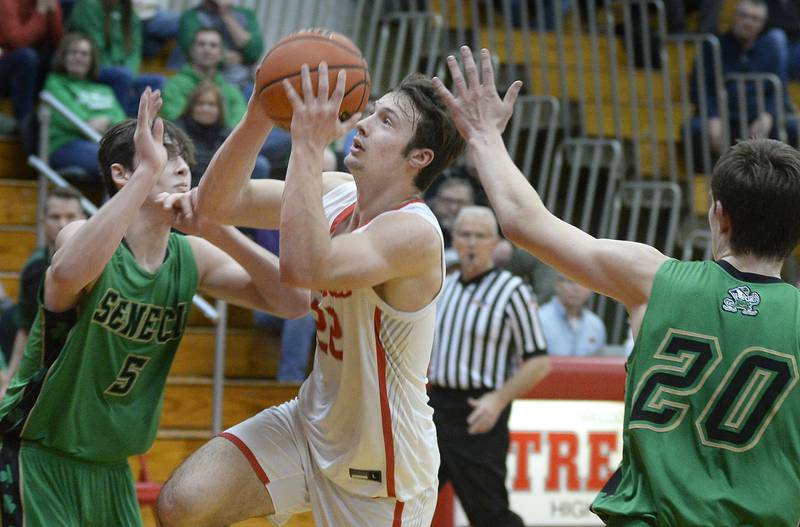 Streator’s Christian Benning goes through Seneca’s Kysen Klinker and Calvin Maierhofer to score in the 2nd period in Pops Dale Gymnasium on Tuesday Feb. 7, 2023 at Streator High School.