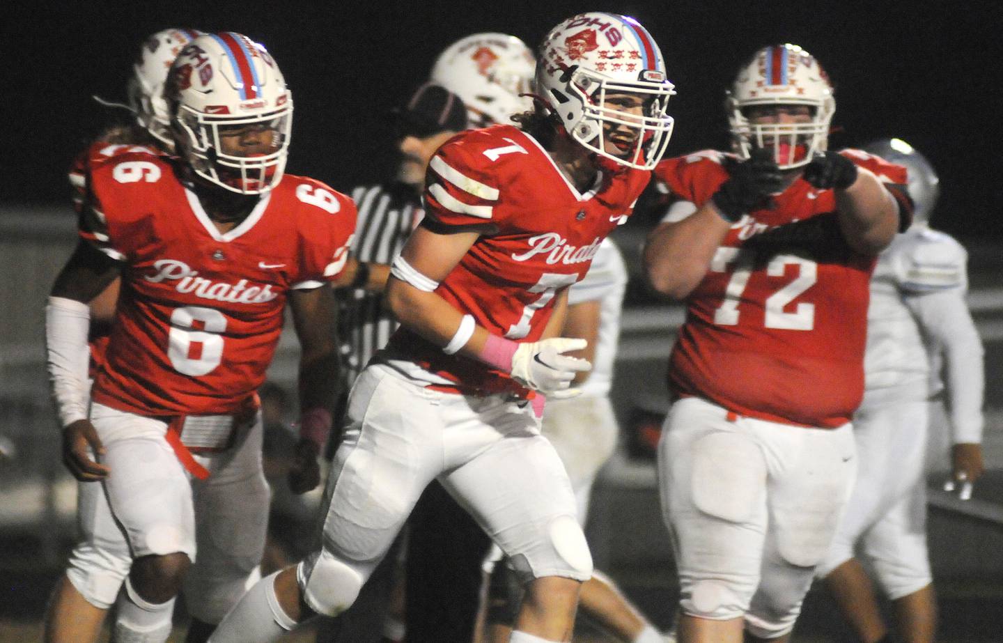 Ottawa teammates Colby Mortenson (6) and Tanner Coglianese (72) help Dillon Quatrano celebrate a touchdown against Woodstock at King Field on Friday, Oct. 21, 2022.