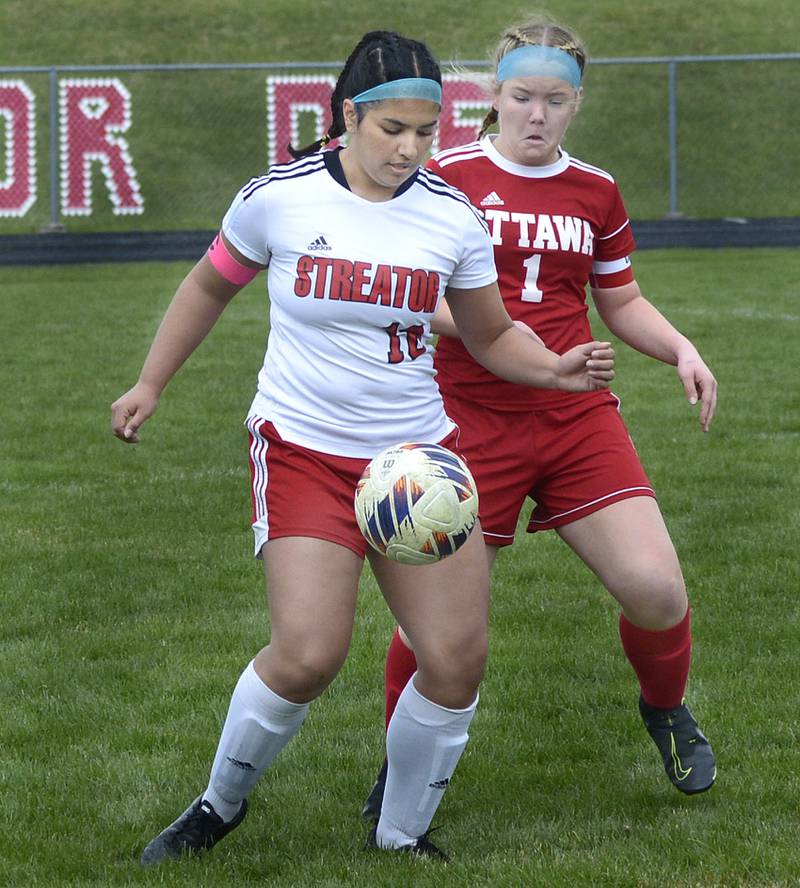 Streator’s  Zuzu Gonzalez and Ottawa’s Isabella Petty battle for control of the ball Saturday at Ottawa.