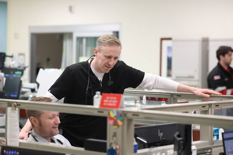 Dr. Mark Bamman gets reports at the start of his evening shift at the Silver Cross Emergency Department on Thursday, April 18, 2024 in New Lenox.