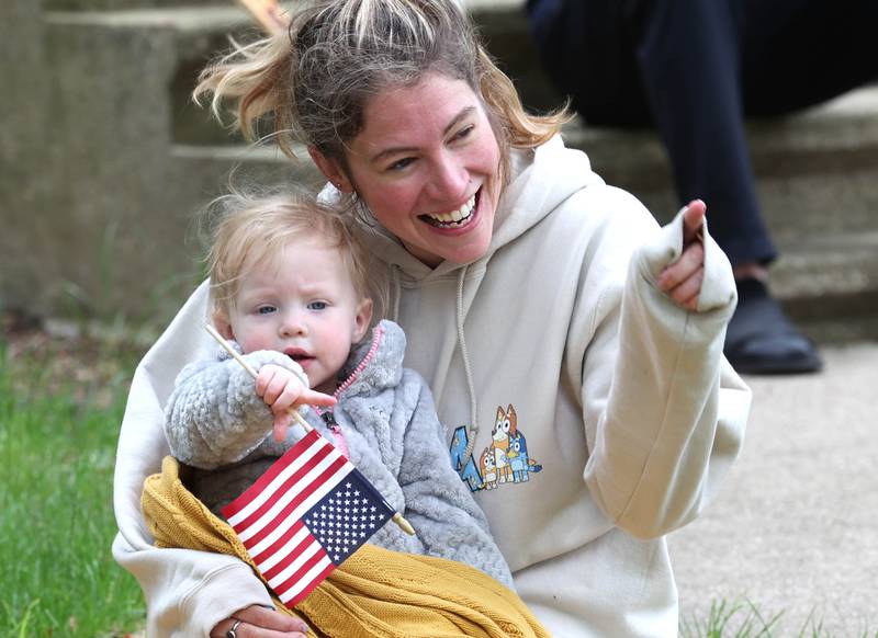 Lauryn Schultz and her daughter Via, 1, from DeKalb, watch the DeKalb Memorial Day parade Monday, May 27, 2024, on West Locust Street.