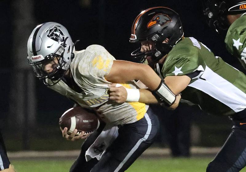 DeKalb's Matthew Clayton sacks Kaneland's Chase Kruckenber during their game Friday, Sept. 13, 2024, at Kaneland High School in Maple Park.