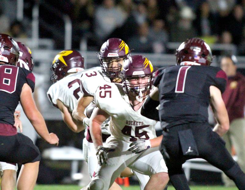 Richmond Burton’s Riley Shea, front, blocks for Oscar Bonilla, Jr. in varsity football at Rod Poppe Field on the campus of Marengo High School in Marengo on Friday, Oct. 18, 2024.